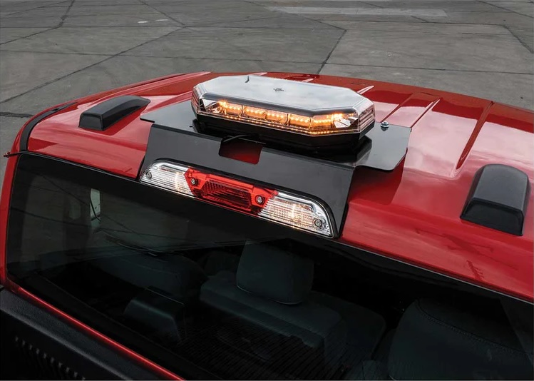 Red truck tail lights glowing brightly against a dark background.