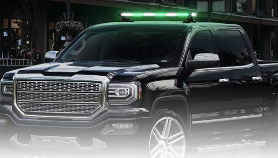 A GMC Sierra 1500 featuring a prominent green light bar on top.