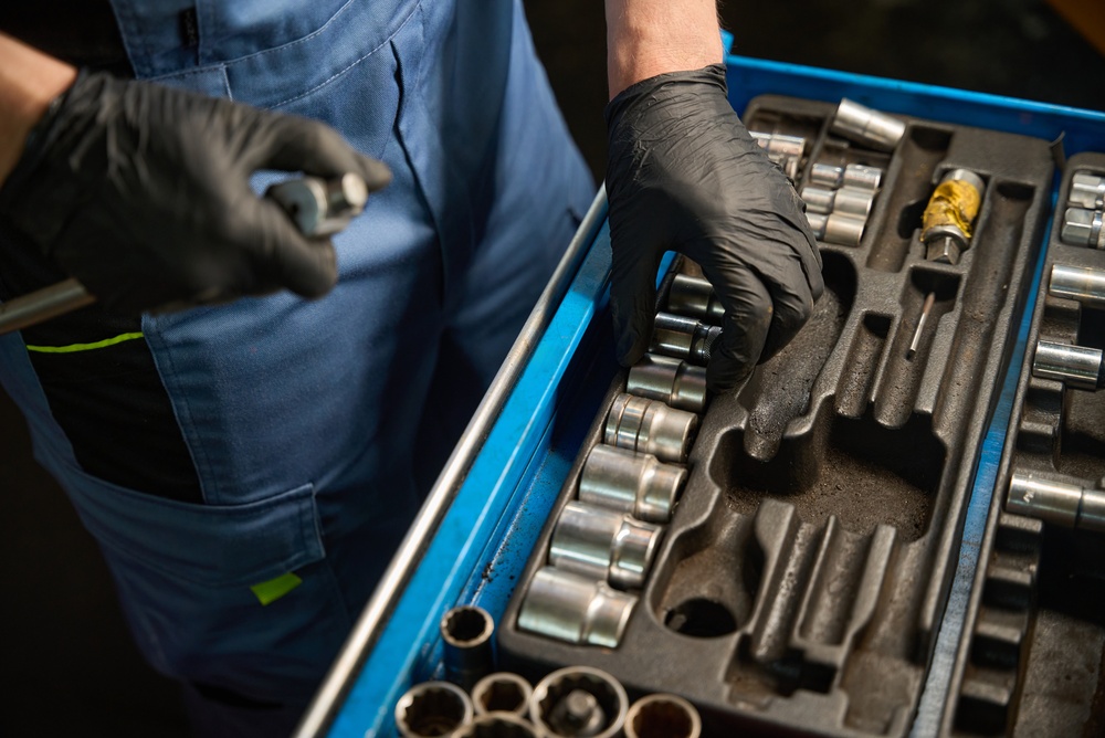 Mechanic is Looking for the right Tools He Needed